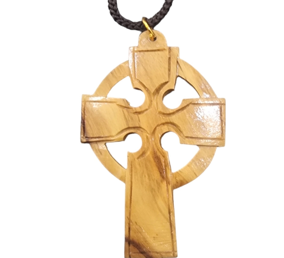 wooden pendants in the shape of a wooden cross made from olive wood in bethlehem, the holy land