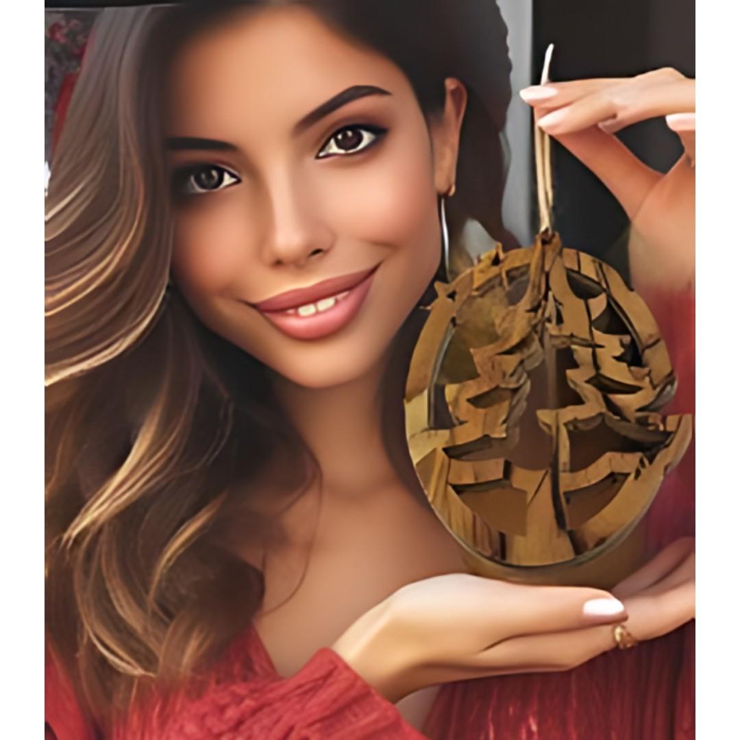 This image shoes a woman holding a christmas tree ornament made from wood